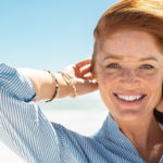 Smiling mature woman at beach